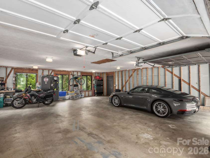 65 Cliff Drive, Laurel Park, NC 28739.  MLS# CAR4394753, YatesRealty ID 39607. The oversized attached two-car garage offers generous space for vehicles, storage, recreational gear