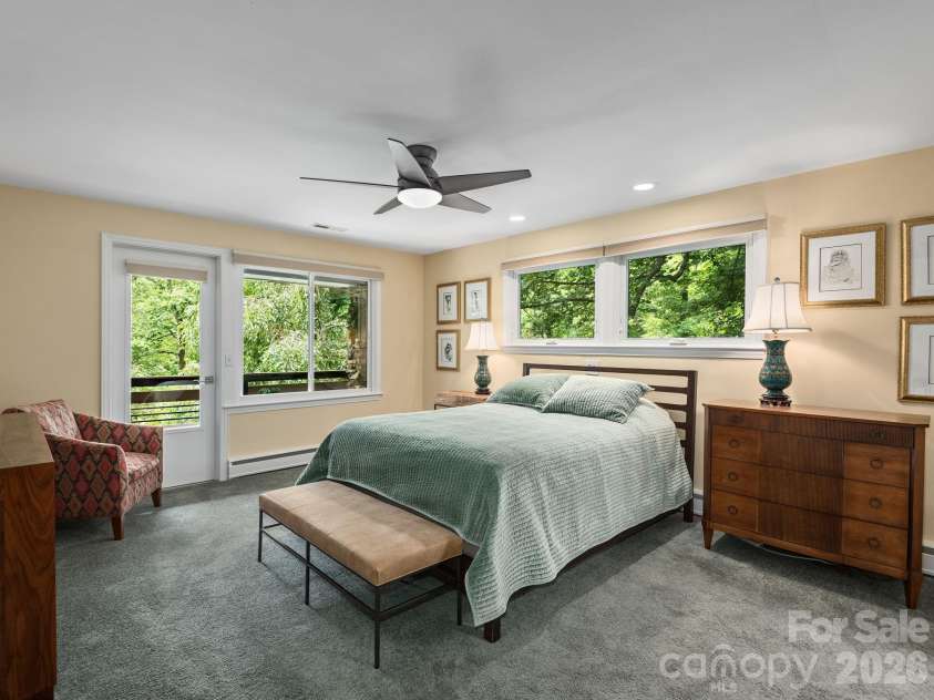 65 Cliff Drive, Laurel Park, NC 28739.  MLS# CAR4394753, YatesRealty ID 39607. Wake up to beautiful views in this spacious primary suite, complete with a private Juliet balcony and large windows