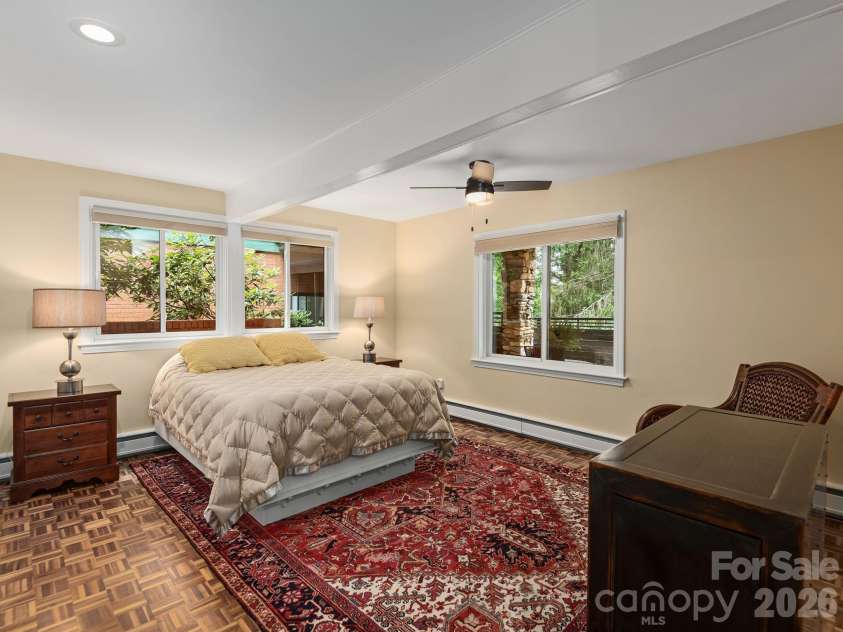 65 Cliff Drive, Laurel Park, NC 28739.  MLS# CAR4394753, YatesRealty ID 39607. Warm original parquet floors and large windows create a bright, inviting lower-level bedroom