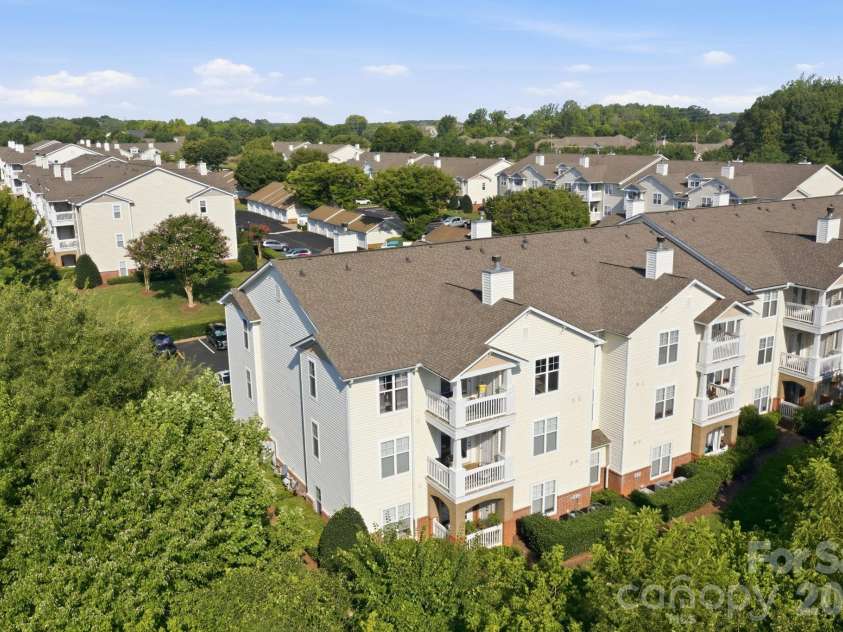 17257 Doe Valley Court, Cornelius, NC 28031.  MLS# CAR4405908, YatesRealty ID 39617. Top Floor Corner Unit surrounded by large, mature, trees