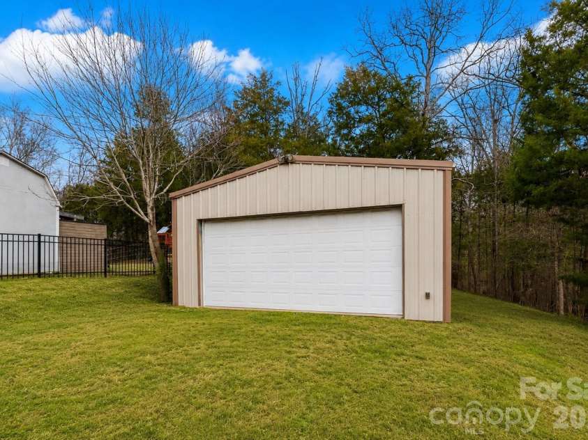 1086 Arrowhead Drive, Concord, NC 28025.  MLS# CAR4397947, YatesRealty ID 39653. Shed with items removed from the front and side