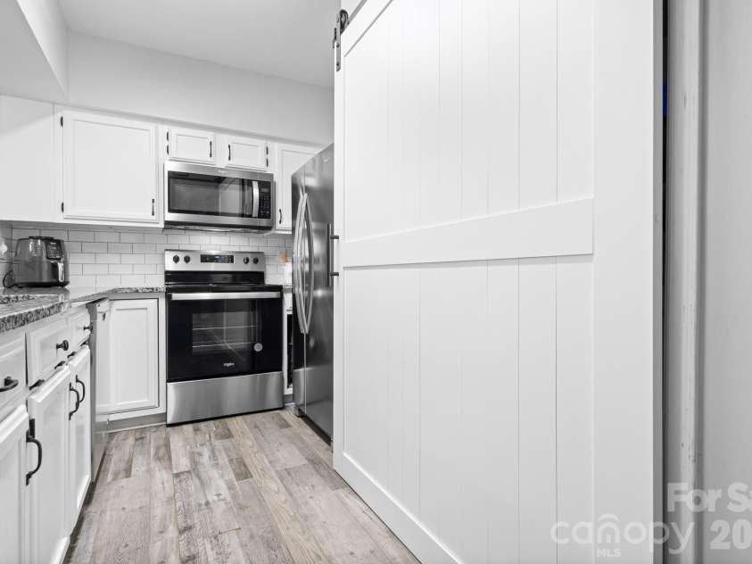19843 Henderson Road, Cornelius, NC 28031.  MLS# CAR4400549, YatesRealty ID 39667. New Barn Door Access Conceals the Convenient Laundry Area and Storage