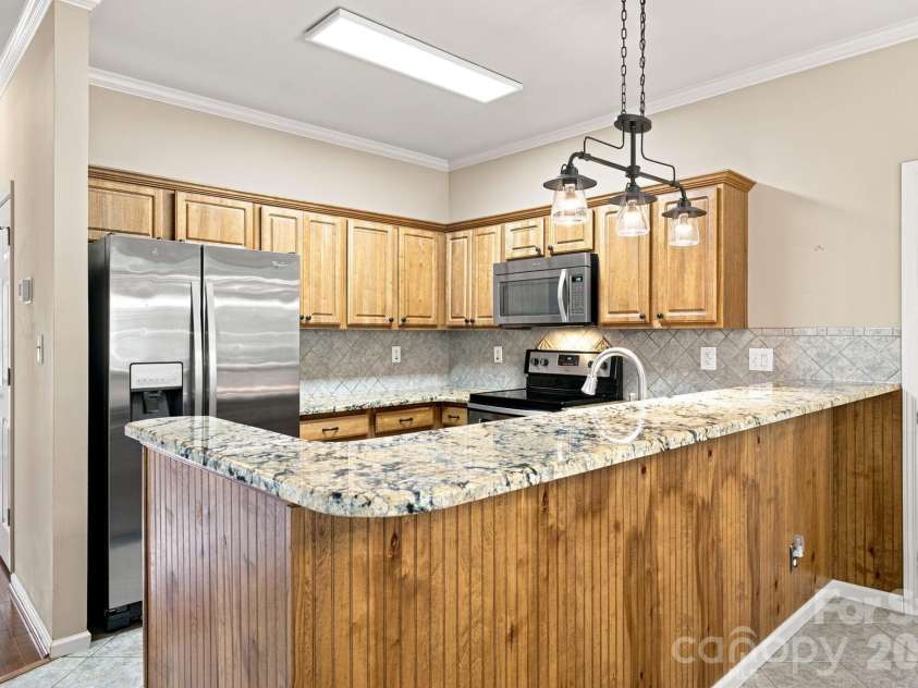 7073 Ridgeway Road, Stanley, NC 28164.  MLS# CAR4406988, YatesRealty ID 39719. Granite counters and breakfast bar