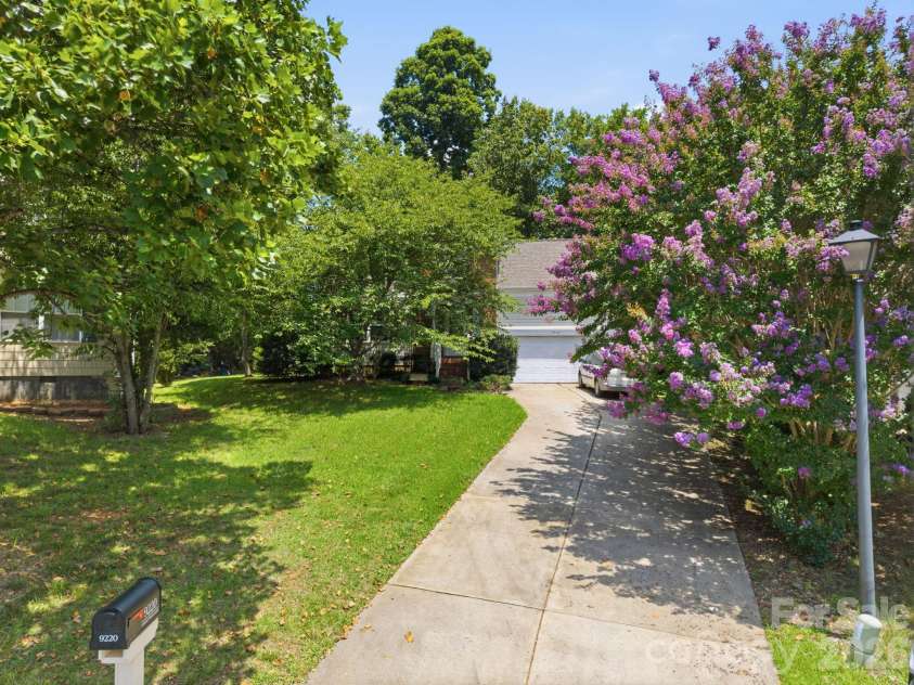 9220 Garnet Field Court, Charlotte, NC 28269.  MLS# CAR4407211, YatesRealty ID 39722. Current front with large tree in front