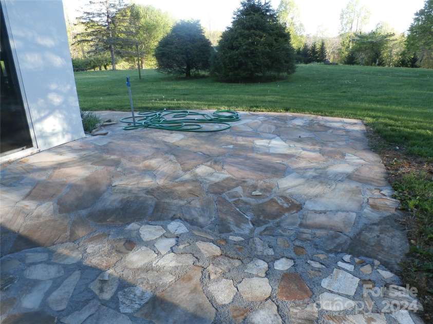 288 Firetower Road, Spruce Pine, NC 28777.  MLS# CAR4135750, YatesRealty ID 3973. Stone patio