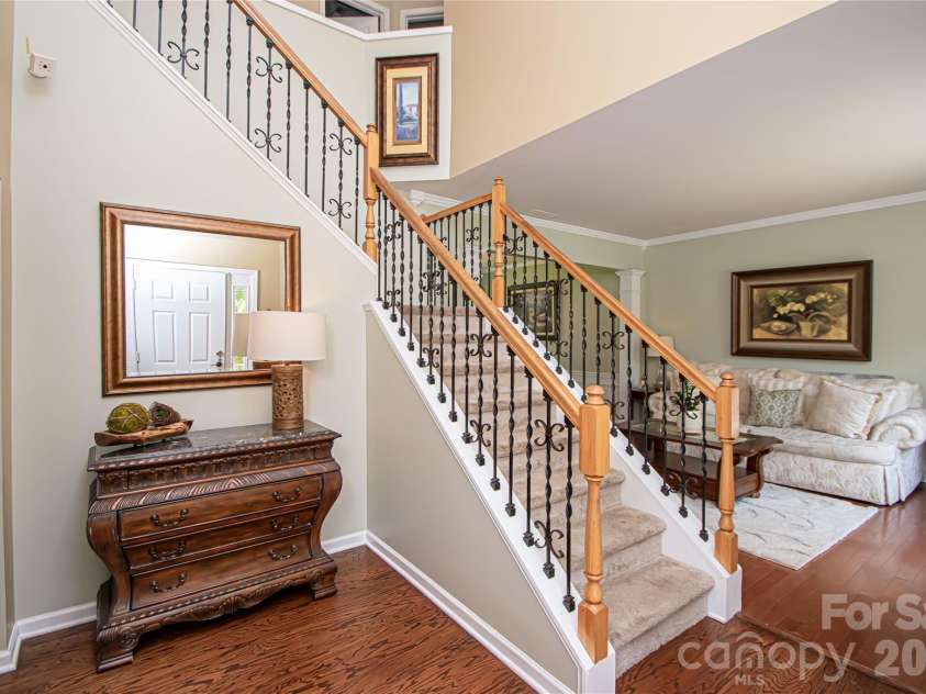 14114 Eldon Drive, Charlotte, NC 28277.  MLS# CAR4406225, YatesRealty ID 39773. A dramatic two-story foyer creates a stunning first impression, highlighted by an elegant staircase with wrought-iron balusters that adds timeless style and architectural appeal.