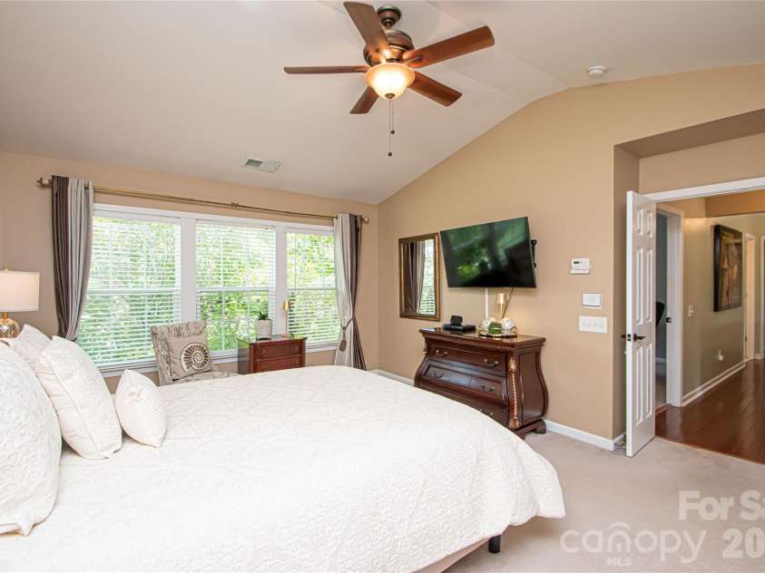 14114 Eldon Drive, Charlotte, NC 28277.  MLS# CAR4406225, YatesRealty ID 39773. The spacious primary suite is a peaceful retreat, featuring a vaulted ceiling, ceiling fan, and an abundance of windows that fill the room with beautiful natural light.
