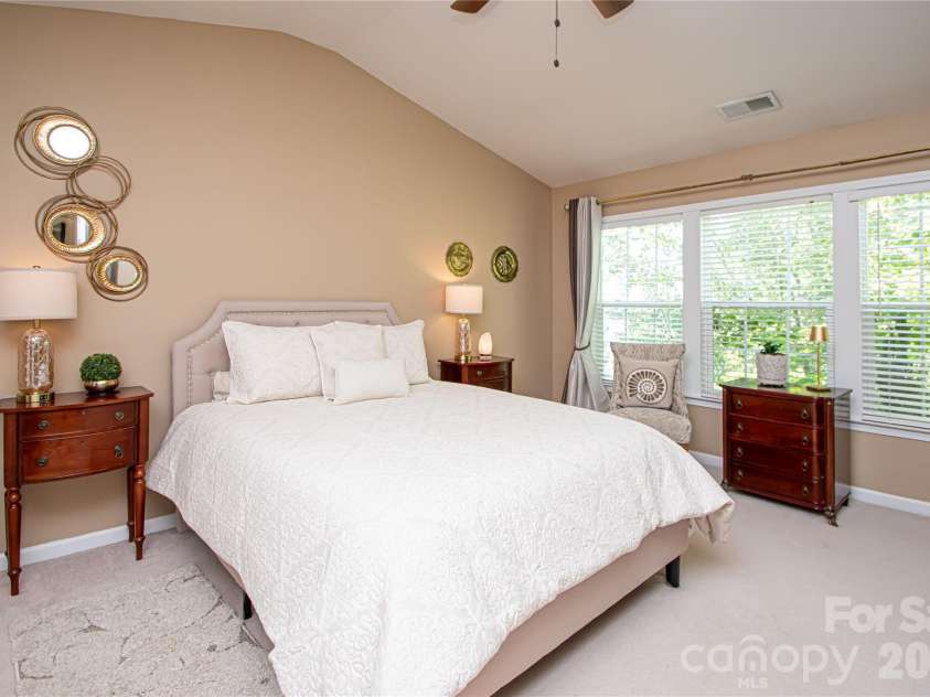 14114 Eldon Drive, Charlotte, NC 28277.  MLS# CAR4406225, YatesRealty ID 39773. The spacious primary suite is a peaceful retreat, featuring a vaulted ceiling, ceiling fan, and an abundance of windows that fill the room with beautiful natural light.