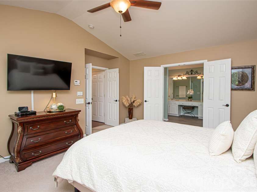 14114 Eldon Drive, Charlotte, NC 28277.  MLS# CAR4406225, YatesRealty ID 39773. The spacious primary suite is a peaceful retreat, featuring a vaulted ceiling, ceiling fan, and an abundance of windows that fill the room with beautiful natural light.