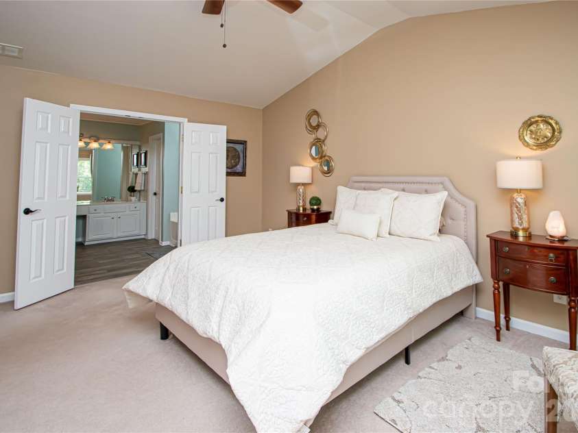 14114 Eldon Drive, Charlotte, NC 28277.  MLS# CAR4406225, YatesRealty ID 39773. The spacious primary suite is a peaceful retreat, featuring a vaulted ceiling, ceiling fan, and an abundance of windows that fill the room with beautiful natural light.