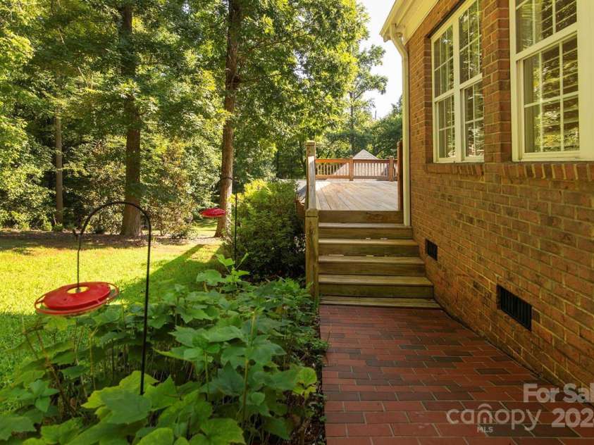 4709 Trey View Court, Mint Hill, NC 28227.  MLS# CAR4173427, YatesRealty ID 3978. Brick walkway from patio to deck-very private lot-great home/yd for entertaining or just enjoy nature - will occasionally see deer in the bkyd1-