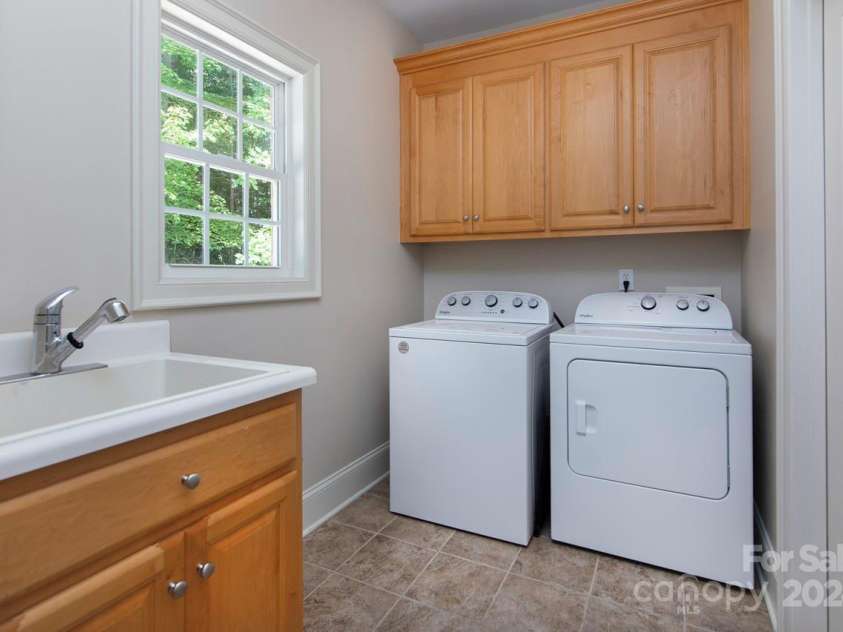 4709 Trey View Court, Mint Hill, NC 28227.  MLS# CAR4173427, YatesRealty ID 3978. Enter laundry rm from the garage. Utility sink & closet for stg.  Mechanical box is on wall-convenient!Dbl doors open from laundry rm into kitchen.