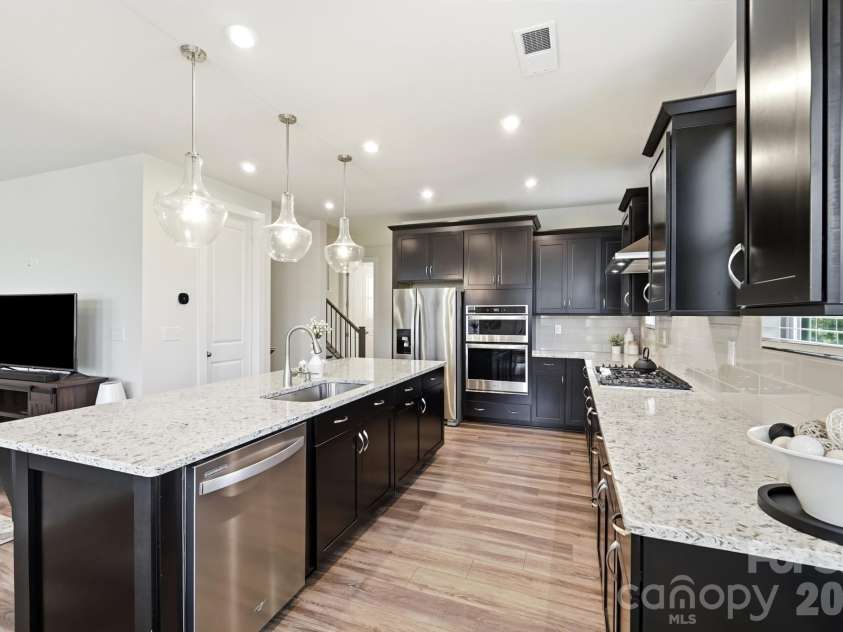 2745 Ensemble Court, Charlotte, NC 28262.  MLS# CAR4405842, YatesRealty ID 39785. Beautiful Maple cabinets stained Espresso
