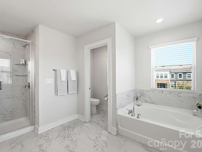 2745 Ensemble Court, Charlotte, NC 28262.  MLS# CAR4405842, YatesRealty ID 39785. Glass shower, soaking tub & tile floors