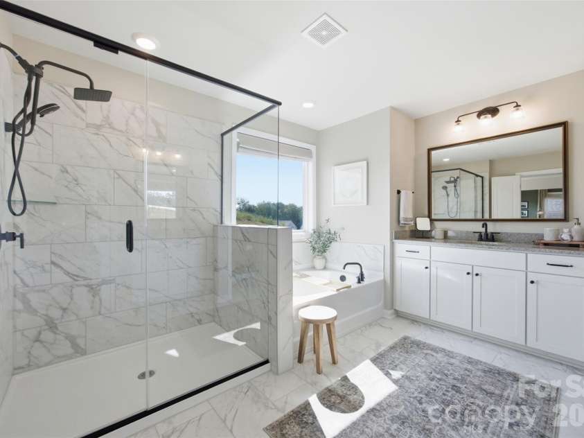 5821 Casper Drive, Charlotte, NC 28214.  MLS# CAR4405553, YatesRealty ID 39797. Large primary bath with separate vanities, oversized shower, and separate bath tub.