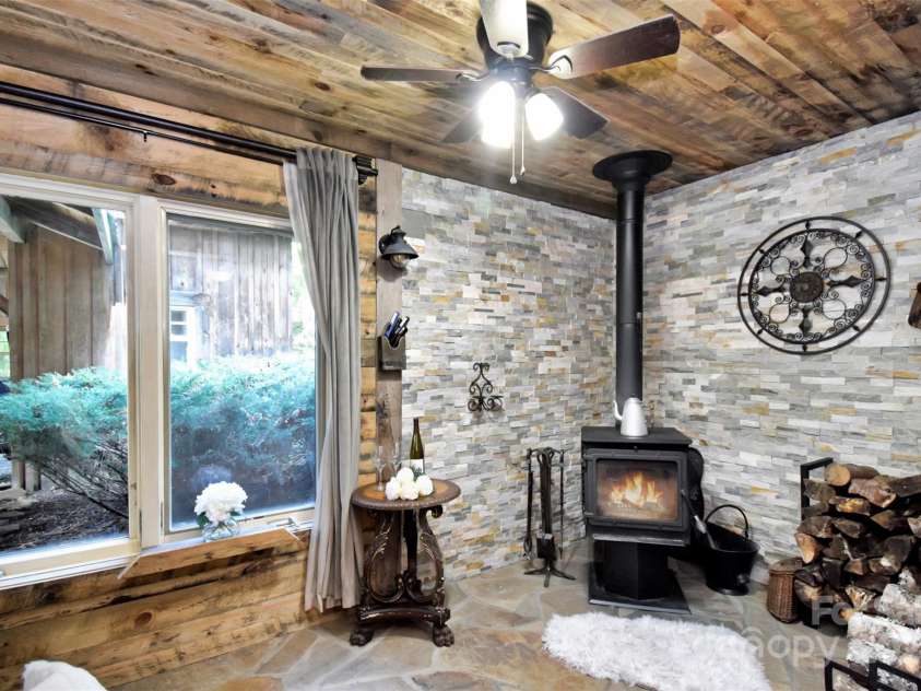 23022 Linville Falls Highway, Linville Falls, NC 28647.  MLS# CAR4178209, YatesRealty ID 3981. Chase away the winter chill in the luxurious hearth room that adjoins the private primary suite.