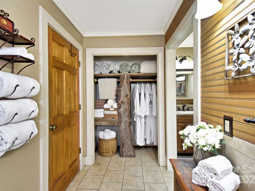 23022 Linville Falls Highway, Linville Falls, NC 28647.  MLS# CAR4178209, YatesRealty ID 3981. Gorgeous live-edge wood, custom built linen closet in primary bathroom
