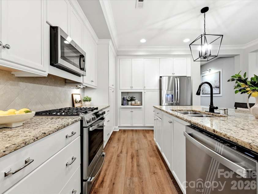 16620 Redding Park Lane, Cornelius, NC 28031.  MLS# CAR4404866, YatesRealty ID 39811. Designed for both function and style, the spacious kitchen offers a large granite island, stainless steel appliances, extensive cabinetry, and a seamless connection to the dining area.
