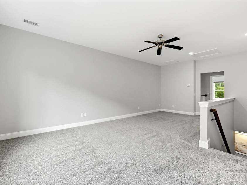 16620 Redding Park Lane, Cornelius, NC 28031.  MLS# CAR4404866, YatesRealty ID 39811. Designed with flexibility in mind, the spacious loft offers endless opportunities for recreation, work, or additional living space.