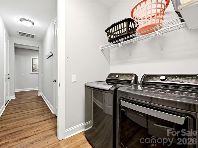 16620 Redding Park Lane, Cornelius, NC 28031.  MLS# CAR4404866, YatesRealty ID 39811. The functional laundry room is equipped with overhead shelving and ample space to keep laundry and household essentials organized.