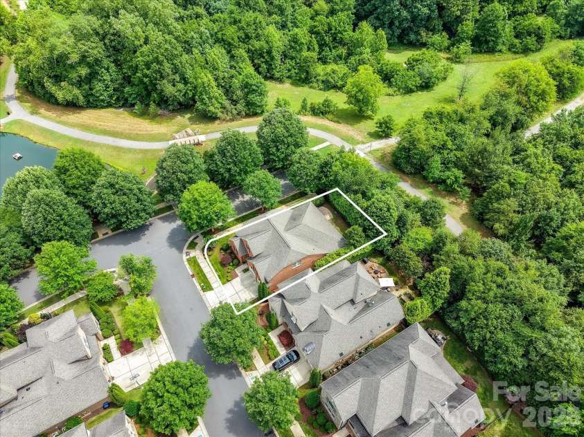 16620 Redding Park Lane, Cornelius, NC 28031.  MLS# CAR4404866, YatesRealty ID 39811. This exceptional homesite backs to scenic walking trails, a tranquil community pond, and lush green space, offering a private setting with beautiful natural surroundings.