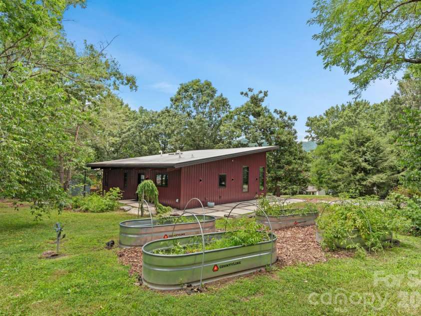 39 Wolf Road, Asheville, NC 28805.  MLS# CAR4397525, YatesRealty ID 39870. Back 3/4 view of house from the raised planter boxes