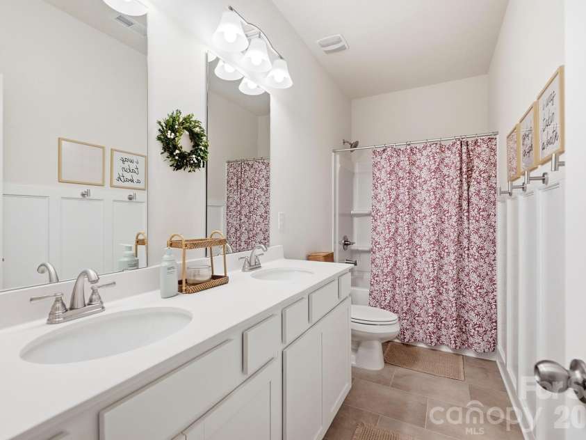 6023 Busch Way, Midland, NC 28107.  MLS# CAR4397614, YatesRealty ID 39883. Full hall bath with double vanity serves the secondary bedrooms.