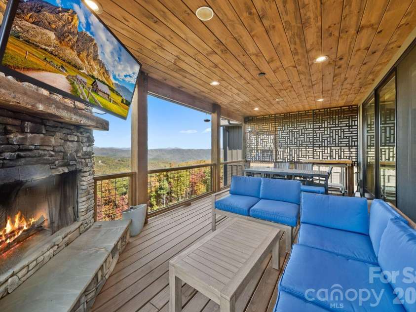 158 Elderberry Circle, Boone, NC 28607.  MLS# CAR4407222, YatesRealty ID 39935. Main level deck with wood burning fireplace