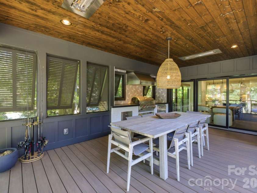 19624 Meta Road, Cornelius, NC 28031.  MLS# CAR4394341, YatesRealty ID 39952. Outdoor kitchen and dining space make hosting easy with dedicated cooking and gathering areas. This image highlights a premium feature for buyers who love to entertain.