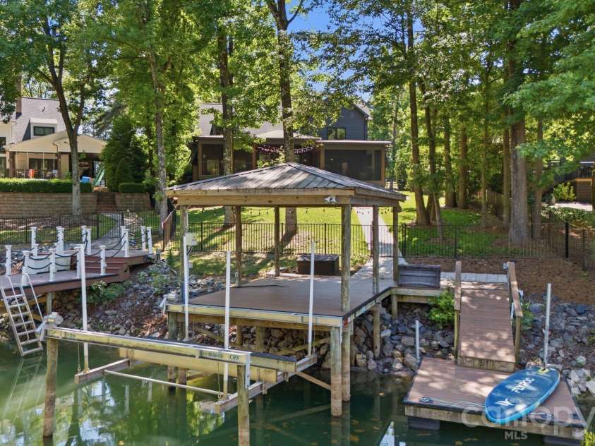 19624 Meta Road, Cornelius, NC 28031.  MLS# CAR4394341, YatesRealty ID 39952. Peaceful waterfront setting invites boating, lounging, and sunset views from the dock. A strong lifestyle image that connects buyers emotionally to the lakefront experience.