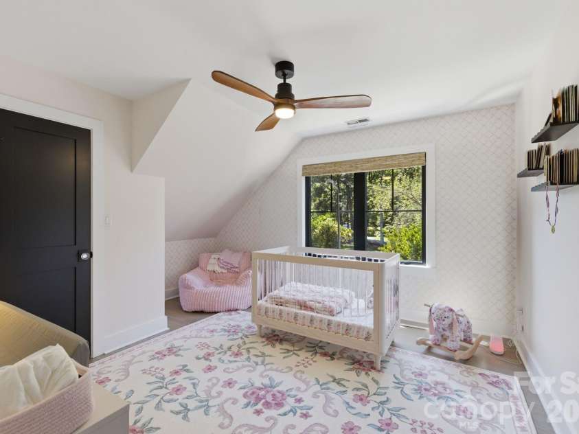 19624 Meta Road, Cornelius, NC 28031.  MLS# CAR4394341, YatesRealty ID 39952. Second upper bedroom provides a bright, inviting space with easy access to nearby bath areas. This room reinforces the home’s practical four-bedroom layout.