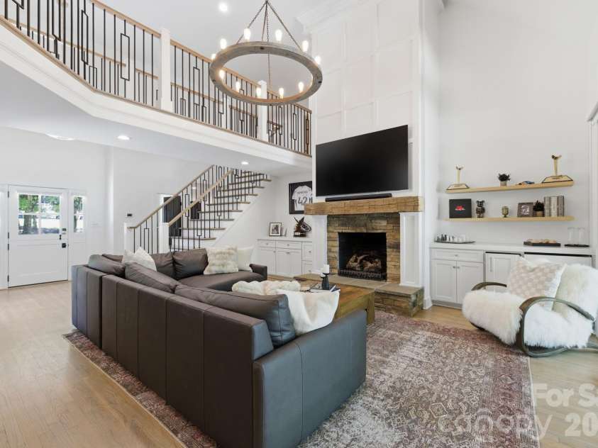 19624 Meta Road, Cornelius, NC 28031.  MLS# CAR4394341, YatesRealty ID 39952. Two-story great room creates a dramatic central gathering space with an airy, elevated feel. Large windows and open sightlines enhance the home’s bright lakeside atmosphere.