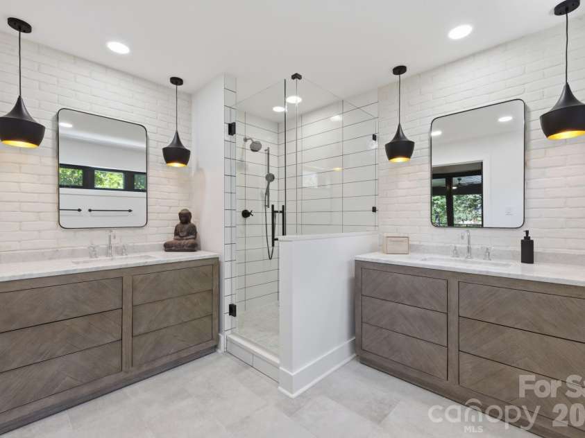 19624 Meta Road, Cornelius, NC 28031.  MLS# CAR4394341, YatesRealty ID 39952. Updated primary bath includes a double vanity with clean finishes and ample storage. The space feels bright, polished, and thoughtfully designed for daily comfort.