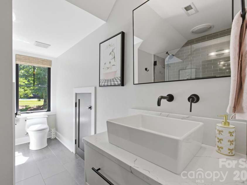 19624 Meta Road, Cornelius, NC 28031.  MLS# CAR4394341, YatesRealty ID 39952. Updated upper bath vanity features clean finishes and convenient storage. This image highlights the thoughtful updates carried through the secondary bath spaces.