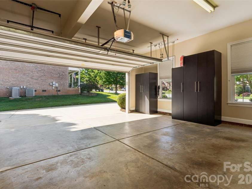 9727 Devonshire Drive, Huntersville, NC 28078.  MLS# CAR4398845, YatesRealty ID 39956. 2-car Garage with storage cabinets.