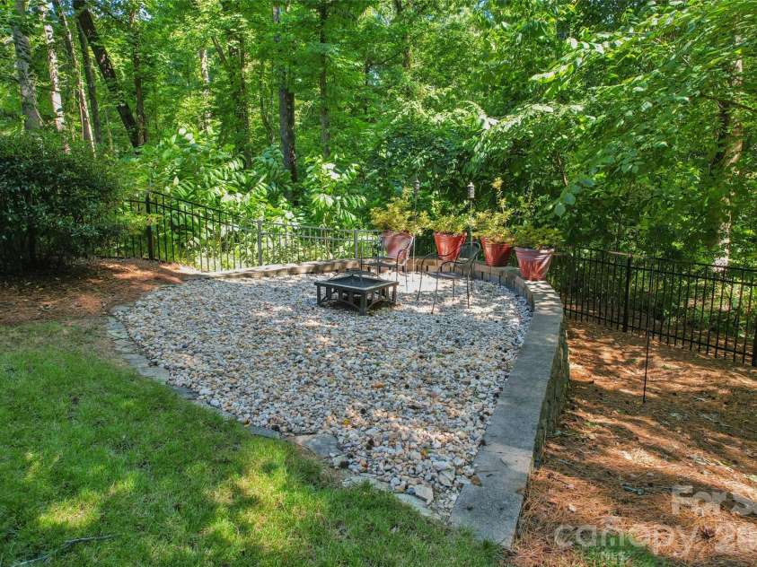 9727 Devonshire Drive, Huntersville, NC 28078.  MLS# CAR4398845, YatesRealty ID 39956. Firepit in backyard.