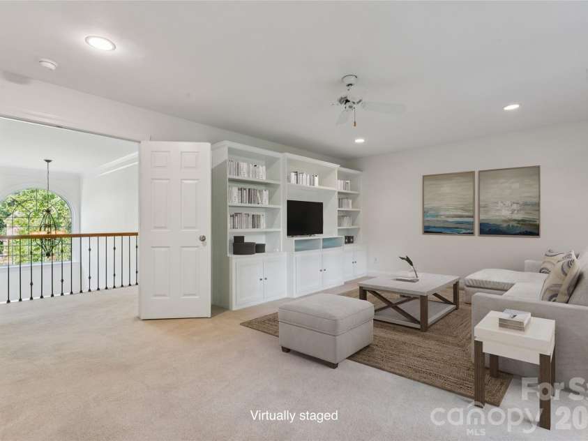 9727 Devonshire Drive, Huntersville, NC 28078.  MLS# CAR4398845, YatesRealty ID 39956. Large bonus room with built in entertainment unit and shelving - virtually staged