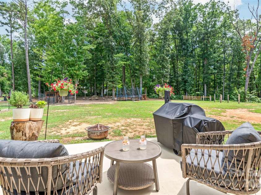 5203 Lawyers Road, Wingate, NC 28174.  MLS# CAR4281064, YatesRealty ID 39962. Patio forest view 