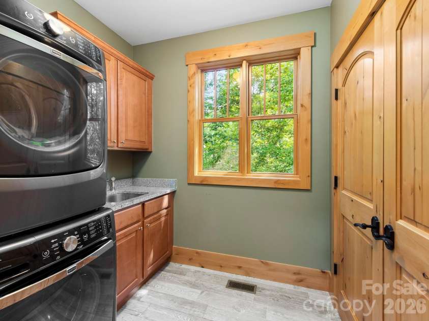 600 White Water Way, Marshall, NC 28753.  MLS# CAR4403673, YatesRealty ID 39990. Laundry room with a sink and a large shelved closet.