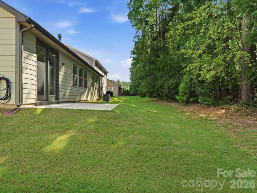 5353 Baker Lane, Clover, SC 29710.  MLS# CAR4401671, YatesRealty ID 39994. This property features a private backyard that backs up to a serene, wooded area.
