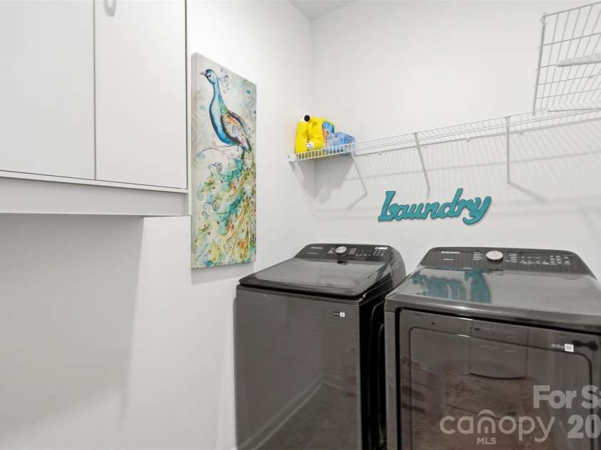 2020 White Cedar Lane, Waxhaw, NC 28173.  MLS# CAR4404030, YatesRealty ID 40006. Large laundry room on main floor off the garage entry, with extra storage.