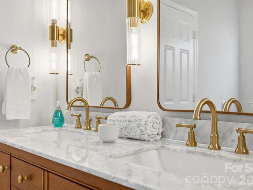 2020 White Cedar Lane, Waxhaw, NC 28173.  MLS# CAR4404030, YatesRealty ID 40006. Primary bath boasts updated lighting and gorgeous hardware