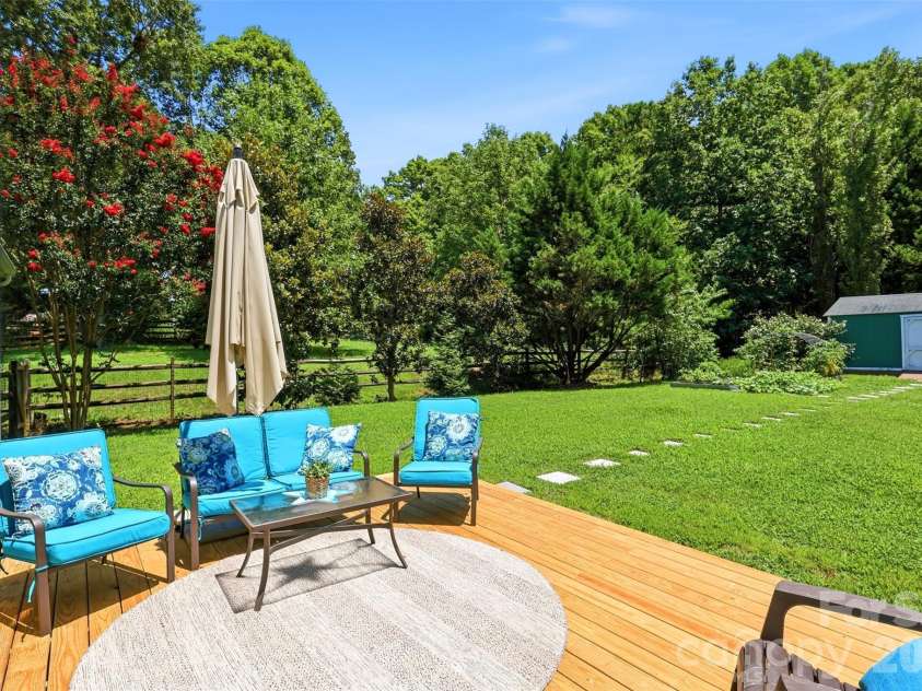 2020 White Cedar Lane, Waxhaw, NC 28173.  MLS# CAR4404030, YatesRealty ID 40006. The rear garden is bordered by many mature trees