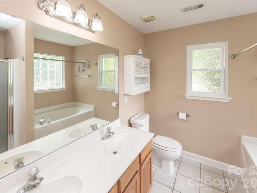 266 Kendra Drive, Concord, NC 28025.  MLS# CAR4401162, YatesRealty ID 40046. Dual vanity bathroom with walk-in shower and soaking tub