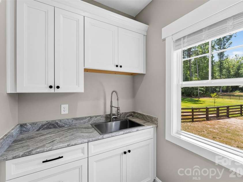 5005 Oconee Drive, Stanley, NC 28164.  MLS# CAR4402337, YatesRealty ID 40096. Laundry room with sink