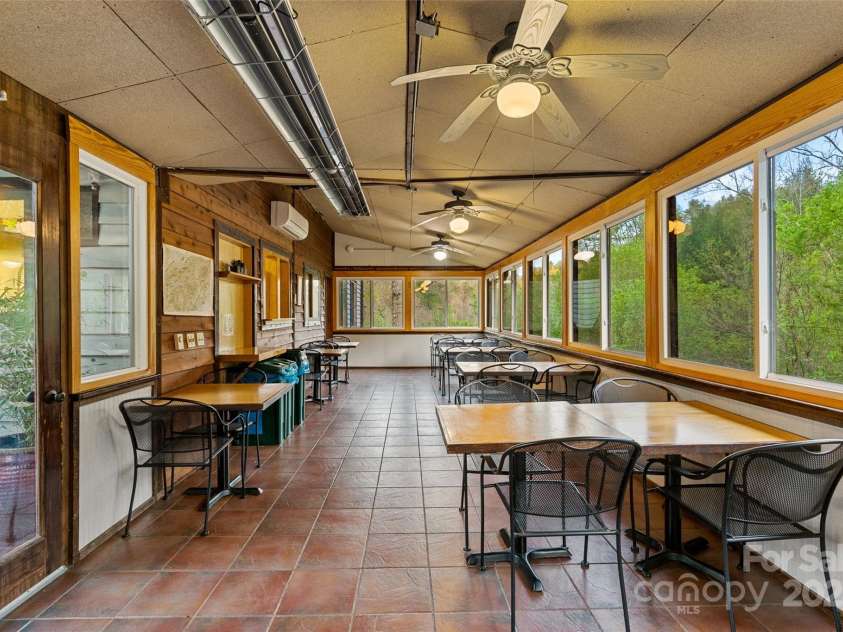 3717 Bend Of Ivy Road, Marshall, NC 28753.  MLS# CAR4209288, YatesRealty ID 401. Dining area of the great room and kitchen of main lodge with treehouse feel