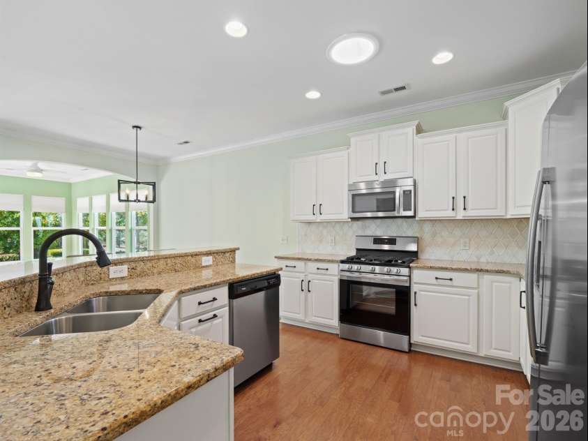 2035 Kennedy Drive, Indian Land, SC 29707.  MLS# CAR4278043, YatesRealty ID 4011. Kitchen with white cabinets and updated backsplash
