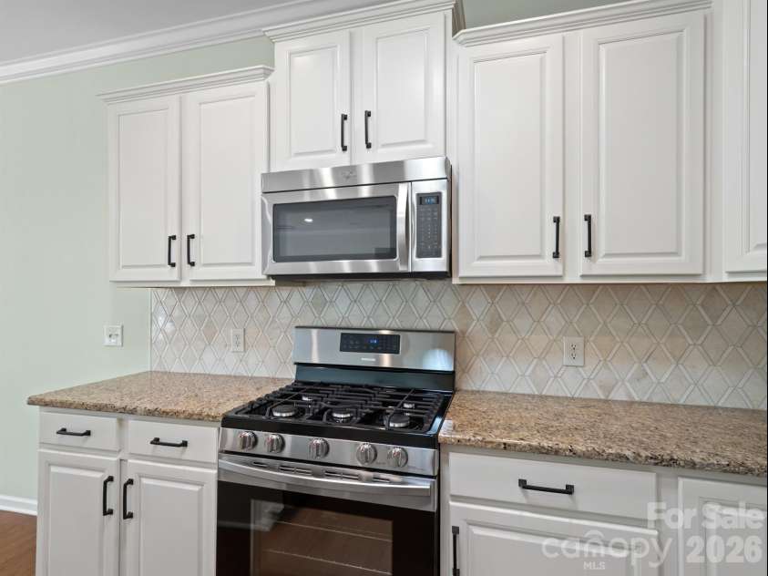 2035 Kennedy Drive, Indian Land, SC 29707.  MLS# CAR4278043, YatesRealty ID 4011. Kitchen with white cabinets and updated backsplash