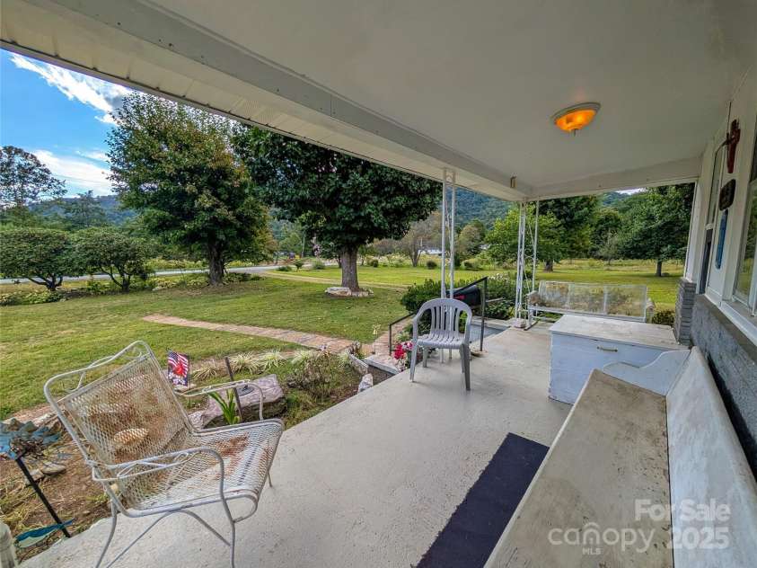 165 Cattail Creek Road, Burnsville, NC 28714.  MLS# CAR4298888, YatesRealty ID 4014. Covered front porch, ideal for relaxation!