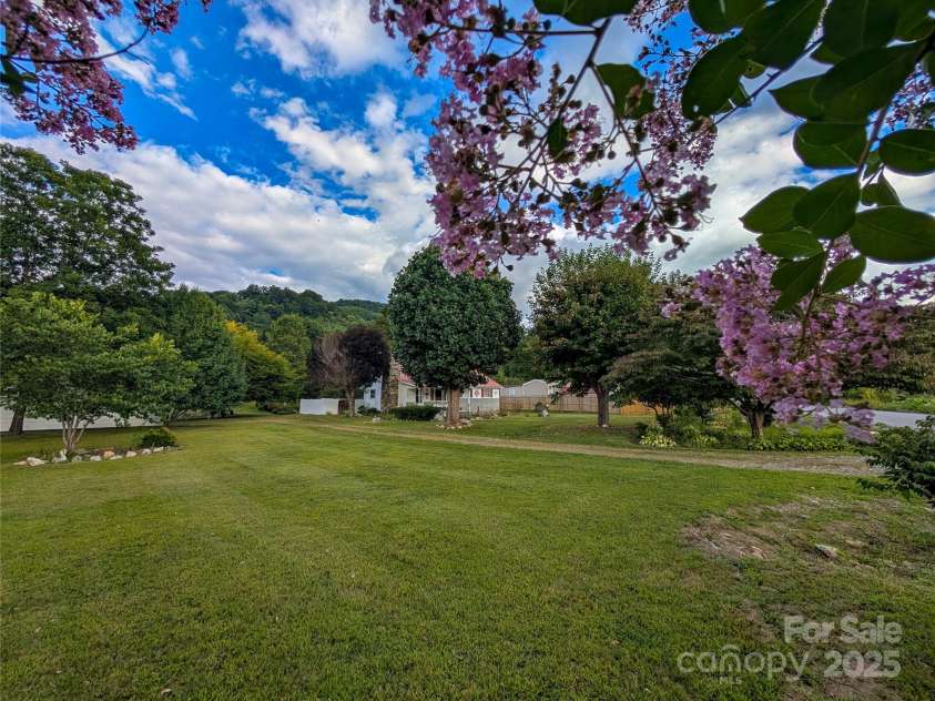 165 Cattail Creek Road, Burnsville, NC 28714.  MLS# CAR4298888, YatesRealty ID 4014. This farmhouse has such a picturesque setting & is situated on 2.74 acres of level usable land!